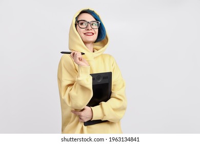 A female designer in yellow hoody holding graphic tablet  The white background