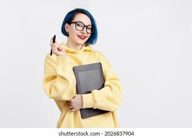 A female designer in yellow hoody holding a graphic tablet. The background is white - Shutterstock ID 2026837904