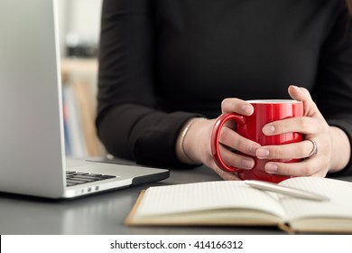 Female designers in office drinking morning tea or coffee. Coffeebreak during hard working day. Girl holding cup of hot beverage.  - Powered by Shutterstock