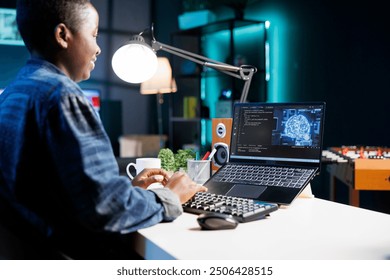 Female developer coding for AI and machine learning on digital laptop. Black woman looking at neural network and database on her personal computer while typing on the keyboard.