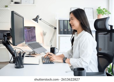 Female developer concentrating on programming tasks at her office.