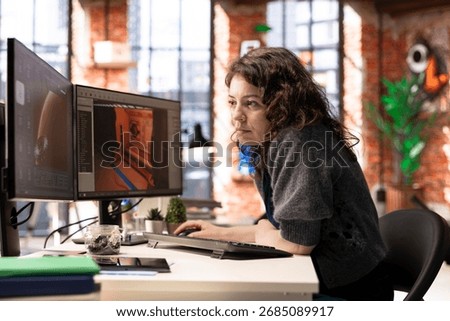Female developer interacts with virtual AI assistant on PC to design a game hub, using automation and machine learning to generate futuristic space station designs for a sci fi video game.