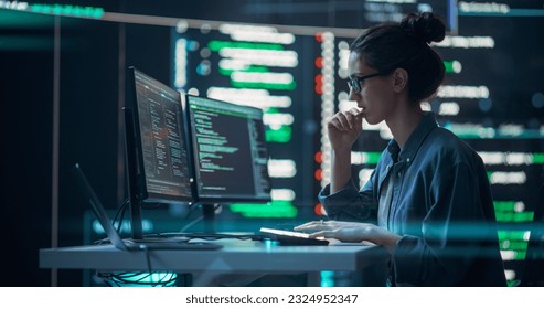 Female Developer Thinking and Typing on Computer, Surrounded by Big Screens Showing Coding Language. Focused Programmer Creating Software, Running Coding Tests. Futuristic Concept of Programming