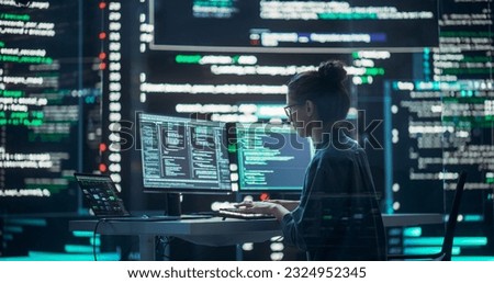 Female Developer Thinking and Typing on Computer, Surrounded by Big Screens Showing Coding Language. Professional Programmer Working in a Modern Office, Running Coding Tests. Futuristic Programming