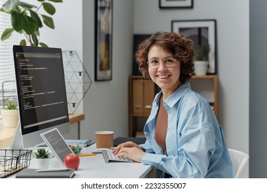 Female developer working on computer at office