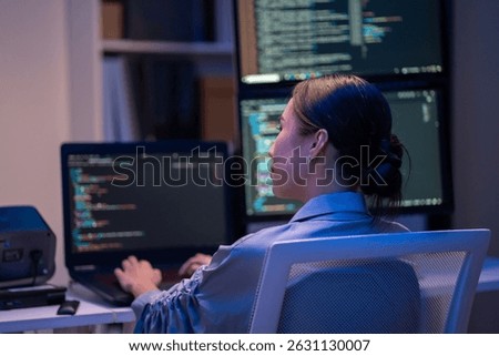 female developer works on complex code displayed across several monitors during a late-night session in office,executive write prompt AI bot IT app program data analytics,AI chatbot technology concept