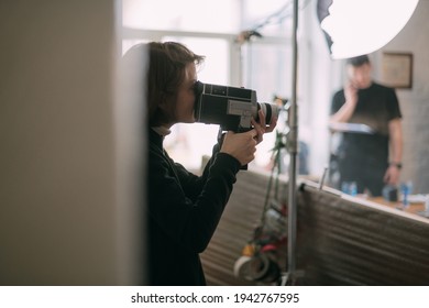 Female Director Of Photography With A Film Camera On The Shooting. Modern Filming Process Of A Film, Advertising On The Set.