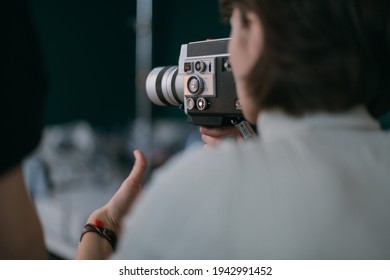 Female Director Of Photography With A Film Camera On The Shooting. Modern Filming Process Of A Film, Advertising On The Set.