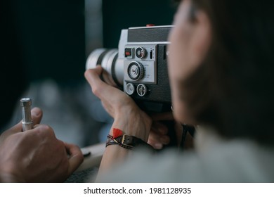 Female Director Of Photography With A Film Camera On The Shooting. Modern Filming Process Of A Film, Advertising On The Set.