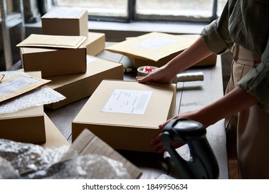 Female distribution warehouse worker or seller packing ecommerce shipping order box for dispatching, preparing post courier delivery package, dropshipping commerce retail shipment service concept. - Shutterstock ID 1849950634