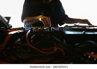 Female Dj Plays Music On Party In Night Club.Professional Disc Jockey Girl Playing Musical Tracks With Retro Analog Turntable,vinyl Records,sound Mixer Device On Stage.Hip Hop Djs Scratch Battle Event