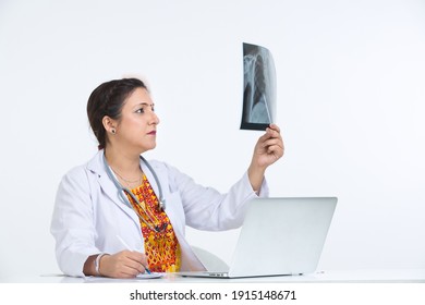 Female doctor analyzing x-ray image. - Powered by Shutterstock