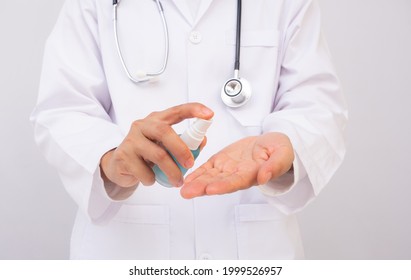 Female Doctor Applying Spray Disinfection Alcohol Product On Hand Disinfecting Hands Against Virus Bacteria Health Prevention In The Day. Demonstration For Using Alcohol In Daily Life