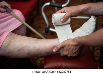 Female Doctor Bandaged Foot Of A Patient