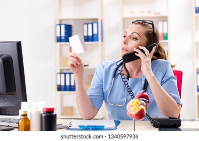 Female doctor cardiologist working in the clinic  - Powered by Shutterstock