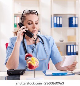 Female doctor cardiologist working in the clinic - Powered by Shutterstock