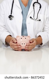Female Doctor with Caring Hands on a Piggy Bank.