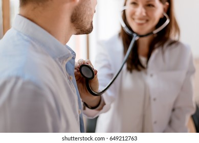 Female Doctor Checking Heart Beat Of Patient.