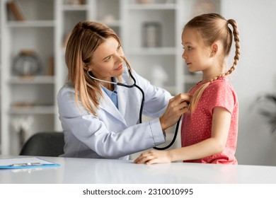 Female doctor checking lungs of little girl during medical checkup in clinic, friendly pediatrician woman using stethoscope to examine breathing and heartbeat of young patient, closeup shot - Powered by Shutterstock