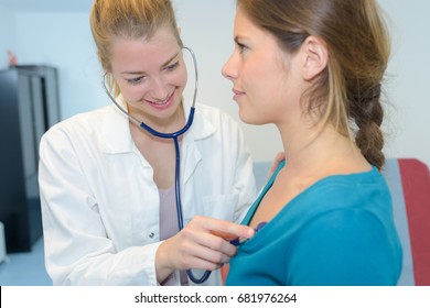 Female Doctor Checking On Female Patient Heart Rate