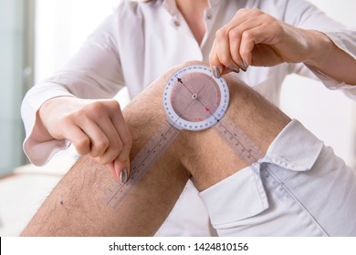 Female doctor checking patient's joint flexibility with goniometer - Powered by Shutterstock