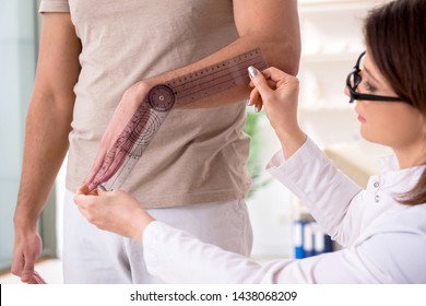 Female doctor checking patient's joint flexibility with goniometer - Powered by Shutterstock