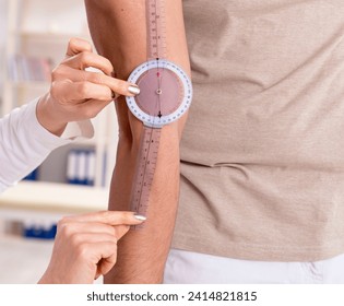 Female doctor checking patient's joint flexibility with goniomet - Powered by Shutterstock