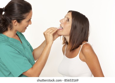 Female doctor checking for sore throat