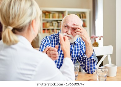 Female doctor consoles a senior with depression or dementia during the consultation - Shutterstock ID 1766603747