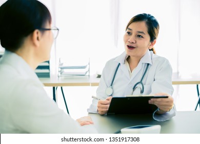 Female doctor consulting patient. Asian people