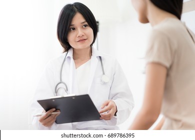 Female Doctor Consulting Patient. Asian People