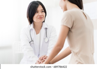 Female Doctor Consulting Patient. Asian People