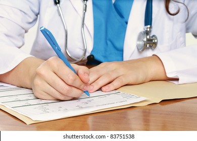 Female Doctor At Desk  - Focus On Hands. Isolated On White Background