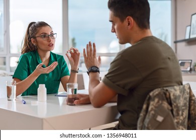 Female Doctor Discussing With Army Soldier And Persuading Him To Take Medicine For His Ptsd Syndrome. 