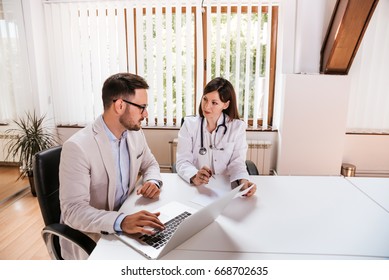Female doctor discussing with manager.