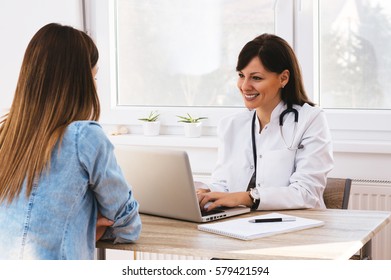 Female Doctor Discussing Report With Patient. Good News At Doctor's