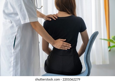 Female Doctor Doing Physiotherapy To Treat Back. Female Office Worker Back Pain Treatment. Doctor, Chiropractor, Office Syndrome.