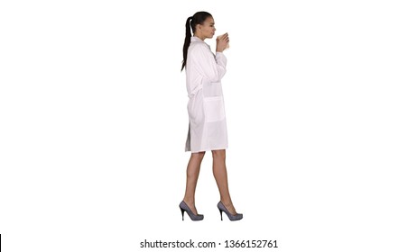 Female Doctor Drinking Coffee And Walking On White Background.