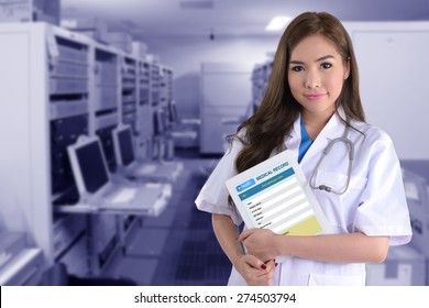 Female Doctor With Electronic Medical Record On Blue Background Of Computer System.