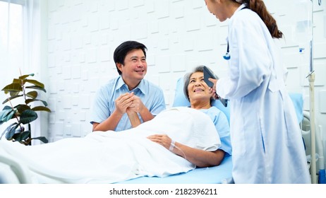 Female Doctor Enters Patient Room To Tell A Better Outcome Of Treatment While Elderly Patients And Her Son Was Having Fun Chatting. Female Patient And A Son Greet The Doctor With Bright Smiles.