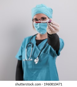 Female Doctor Examines A Blood Sample For The Corona Virus - Studio Photography