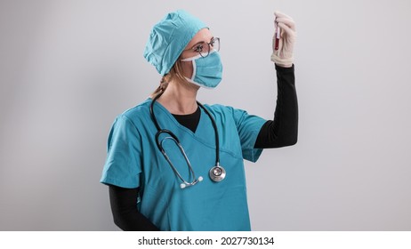 Female Doctor Examines A Blood Sample For The Corona Virus - Studio Photography