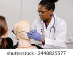 Female doctor examines mannequins head