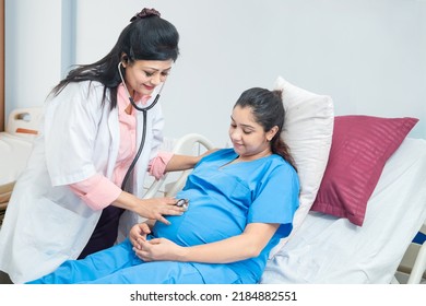 Female Doctor Examining Indian Pregnant Woman Holding Stethoscope Near Belly Listening Baby's Heartbeat at hospital or clinic . Pregnancy Checkup. - Shutterstock ID 2184882551
