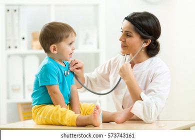 female doctor examining kid little child boy - Powered by Shutterstock