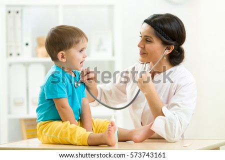 female doctor examining kid little child boy