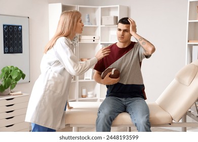 Female doctor examining rugby player with brain concussion in clinic - Powered by Shutterstock