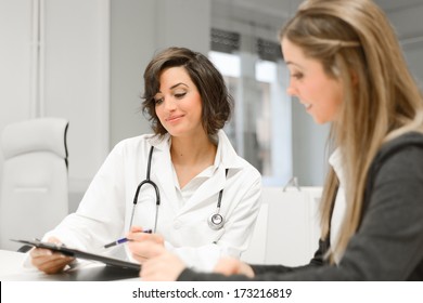 Female Doctor Explaining Diagnosis To Her Female Patient 