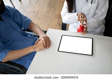 Female Doctor Explaining Health Exam To Male Patient.