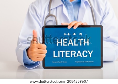 Female doctor explaining health knowledge on tablet screen with thumbs up, Health Literacy concept.